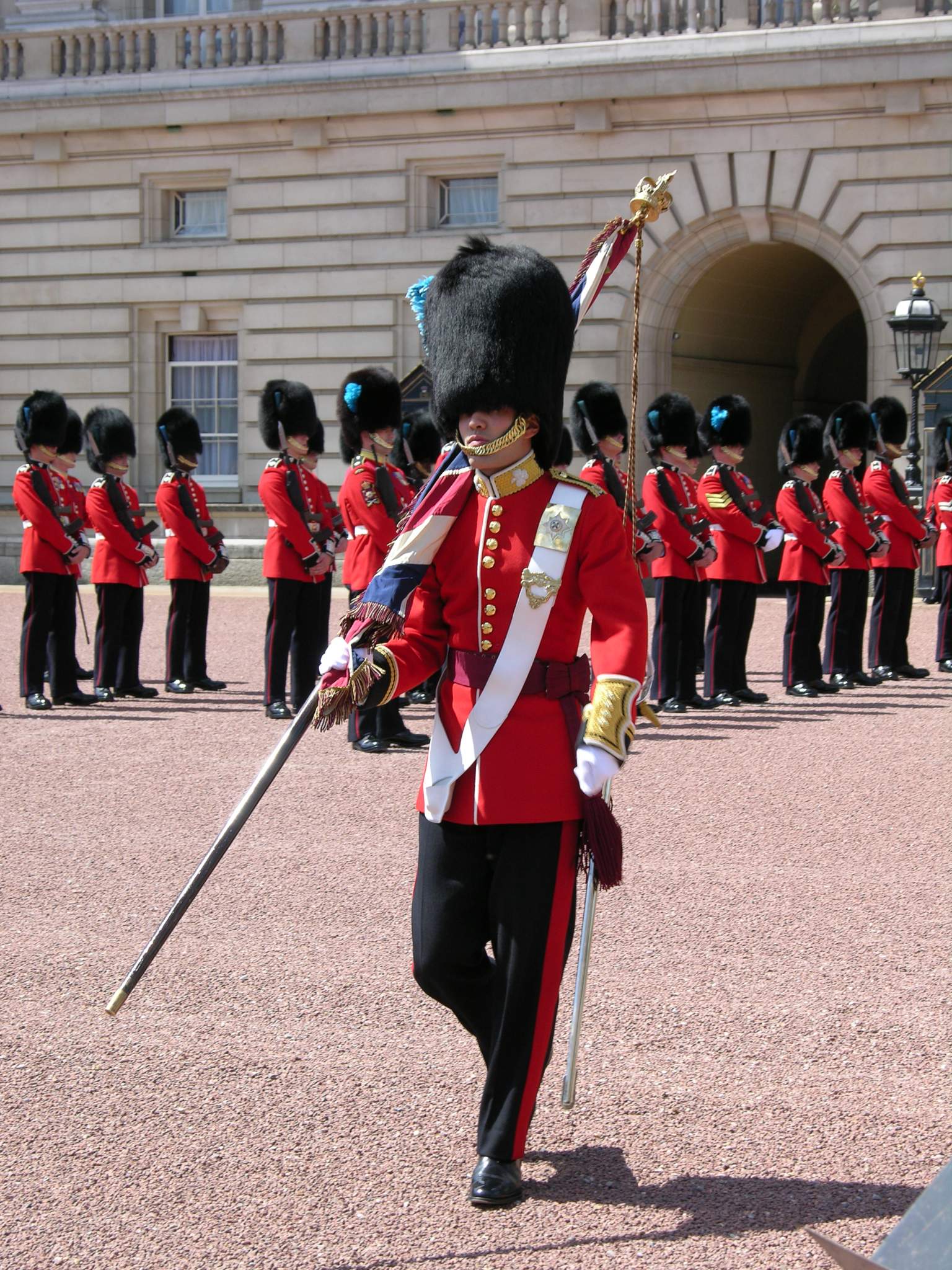 London 01 14 Buckingham Palace Changing of the Guard The Changing of the Guard takes place in the forecourt of Buckingham Palace and lasts a grueling 45 minutes. Members of the Old Guard repeatedly march to the fence within inches of the tourists, before turning and walking back.